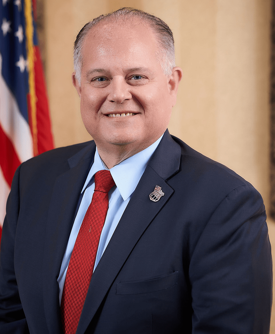 Smiling man in suit with American flag